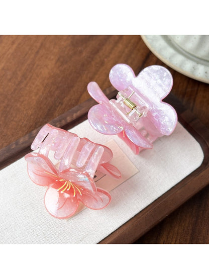 Beau floral claw clip open to display metal spring mechanism and flower details