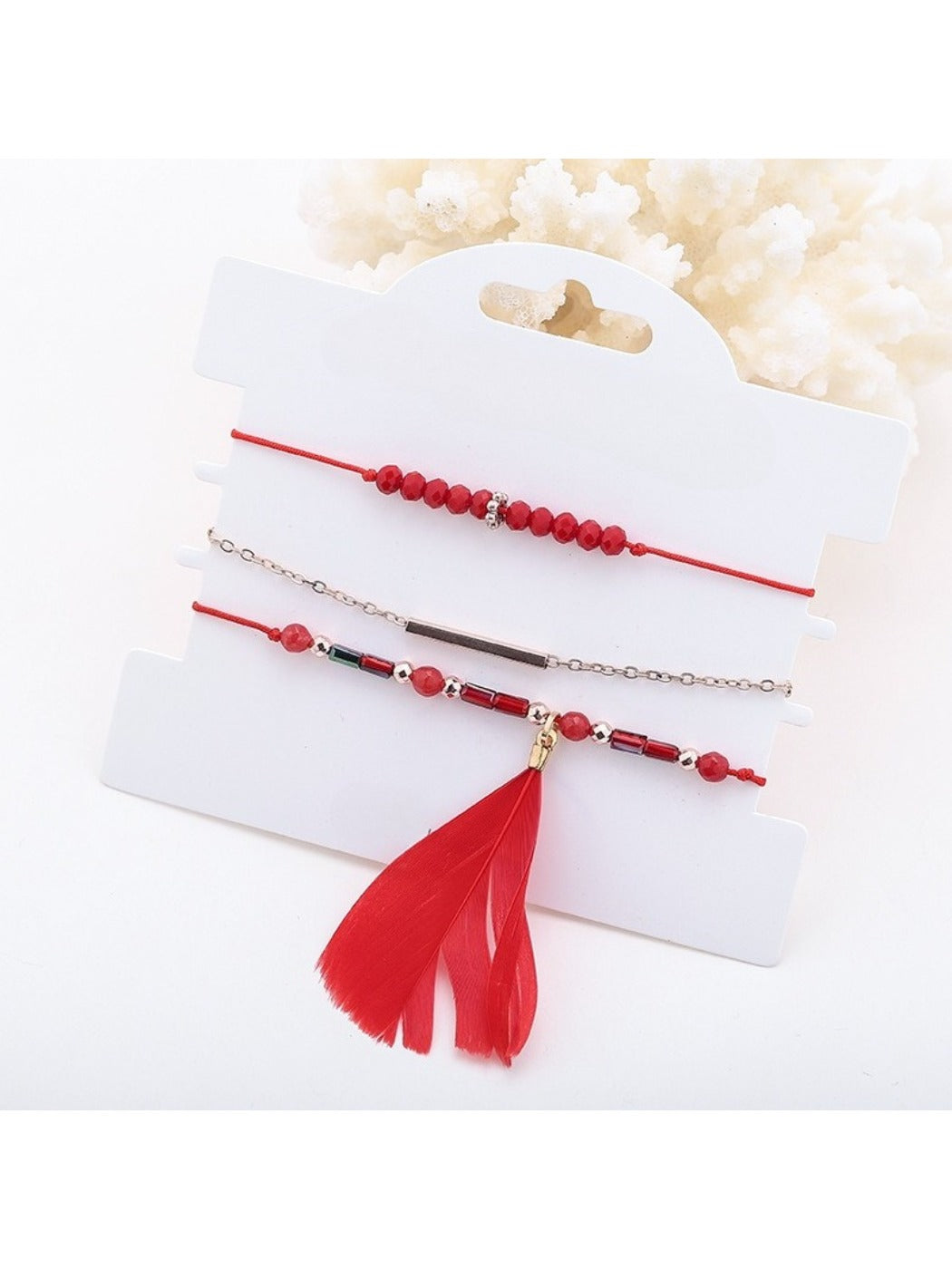 Side view of Lovra small bead bracelet featuring detailed feather pendant