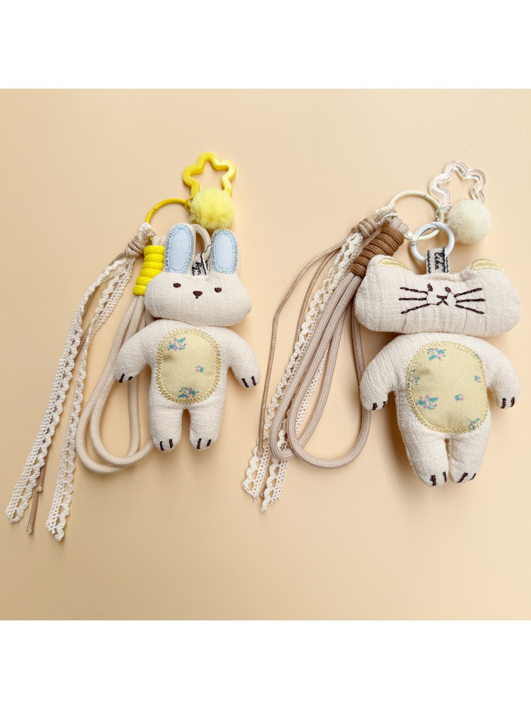 Fabric keychain shaped like a white rabbit with stitched details and a metal ring