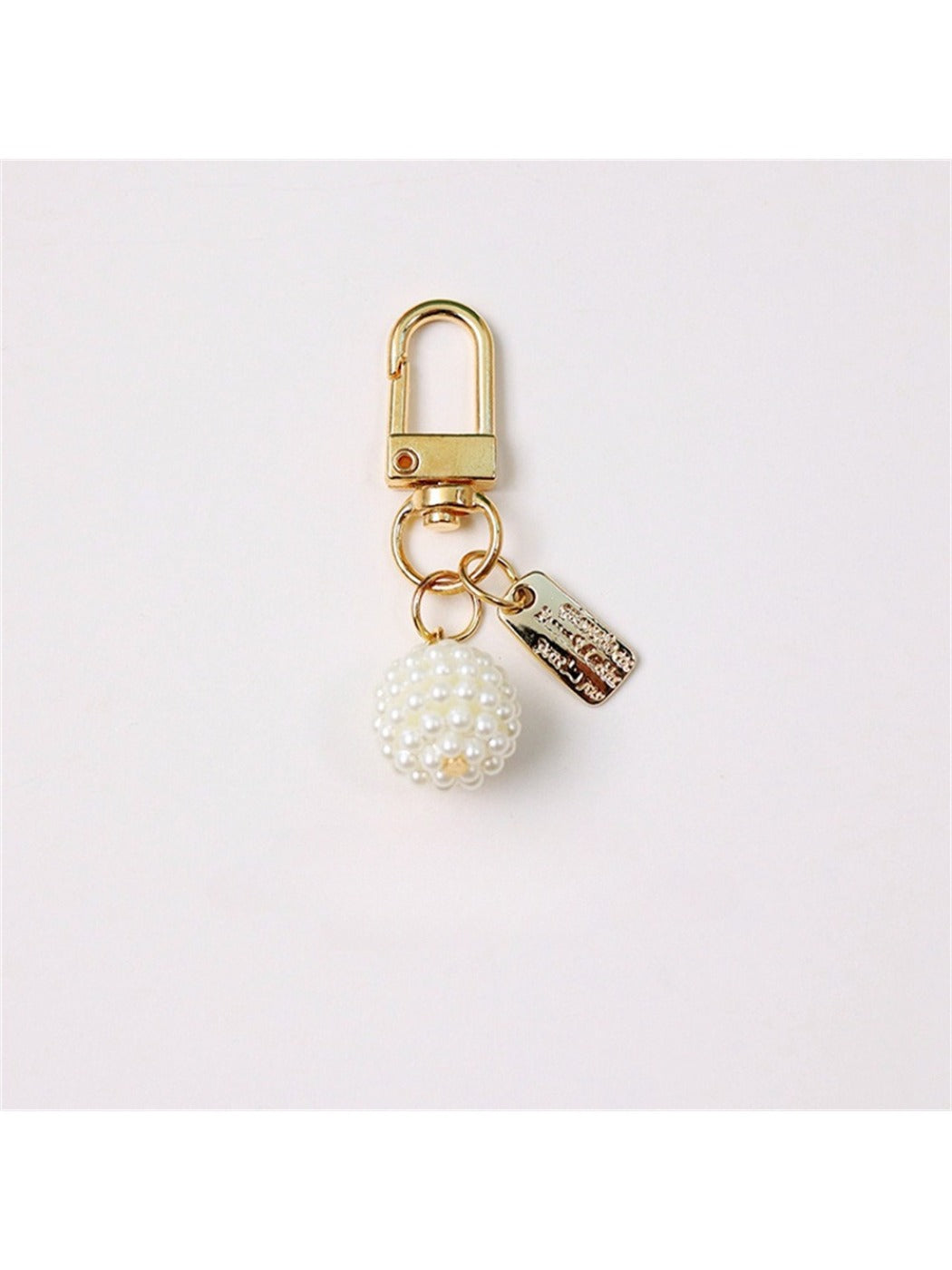 Hand holding Keypus beaded bow charm keychain showing size and detail of beads and bow