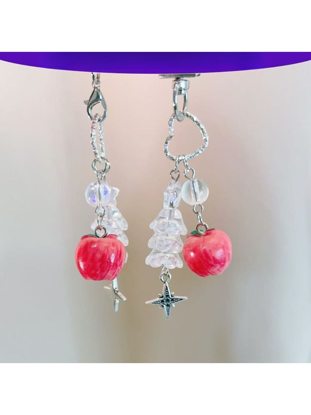 Mini apple-shaped keychain with a red glossy finish and silver keyring