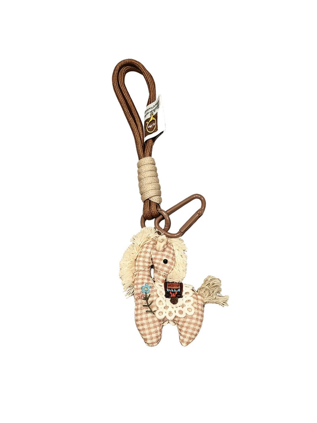Fabric pony bag charm keychain displayed on a wooden surface