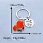 Boxing glove keychain hanging from a backpack zipper pull