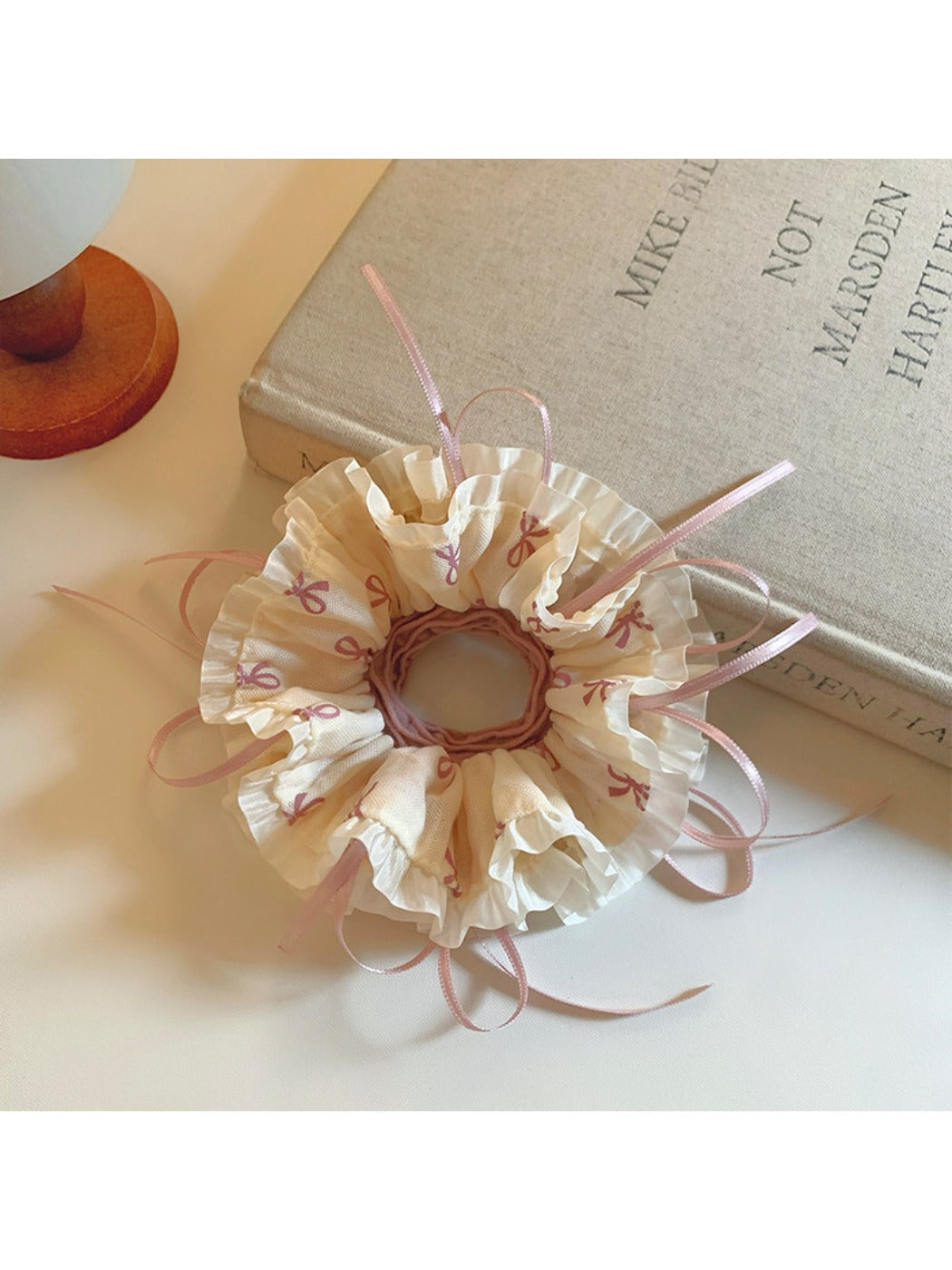 Close-up of Gifty scrunchie showing detailed bow pattern