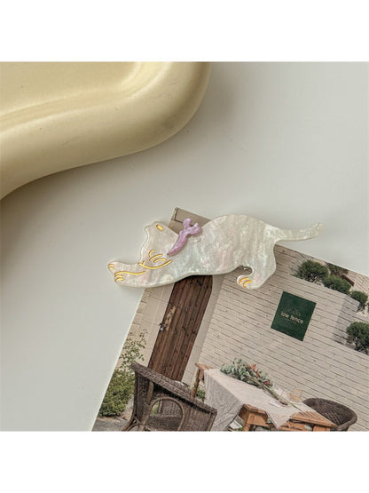 Beau hair clip with cat face design displayed on a flat surface