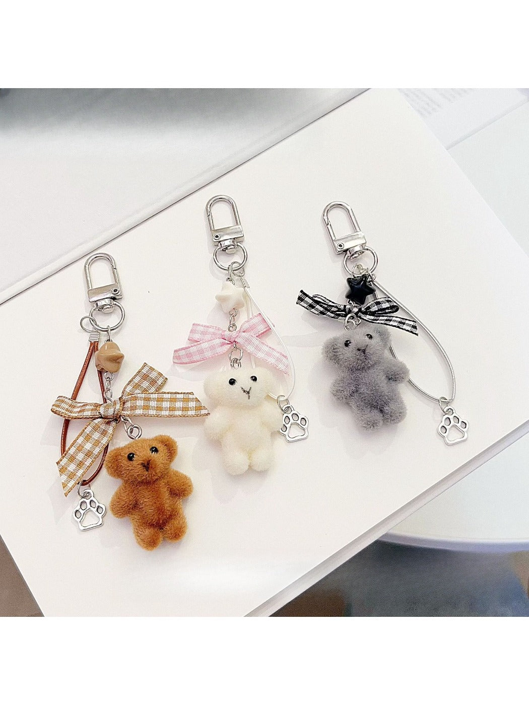 Close-up of Keypus bear keychain showing soft flocked texture and facial details