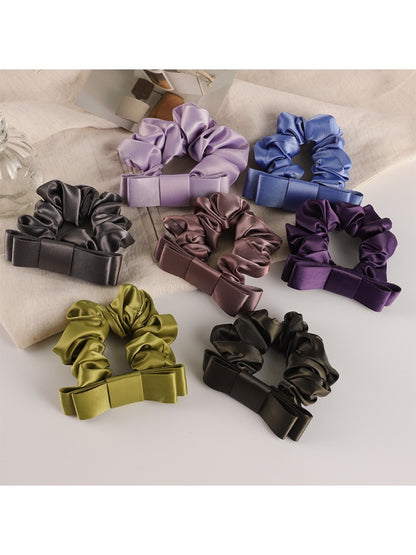 Close-up of scrunchie fabric texture showing soft, smooth material and floral design