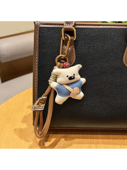 Top view of fabric bear keychain highlighting its shape and fabric pattern
