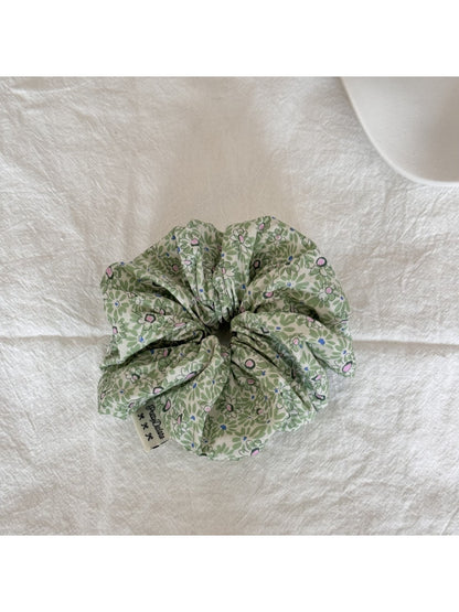 Gifty Sweet Green Style Scrunchie paired with matching green accessories on a wooden surface