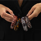 Side view of Lovra vintage asymmetrical leopard print bangle bracelet