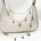 Keypus marine charm bag charm displayed hanging from a handbag handle