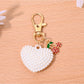 Close-up of gold clasp on red heart shaped bag charm keychain