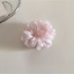 Model holding a minimalist solid color scrunchie in hand