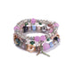 Lovra bracelet laid flat showing multiple rows of gold and pearl beads