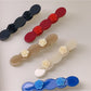Side view of Beau rose decorated wavy hair clip highlighting clip mechanism