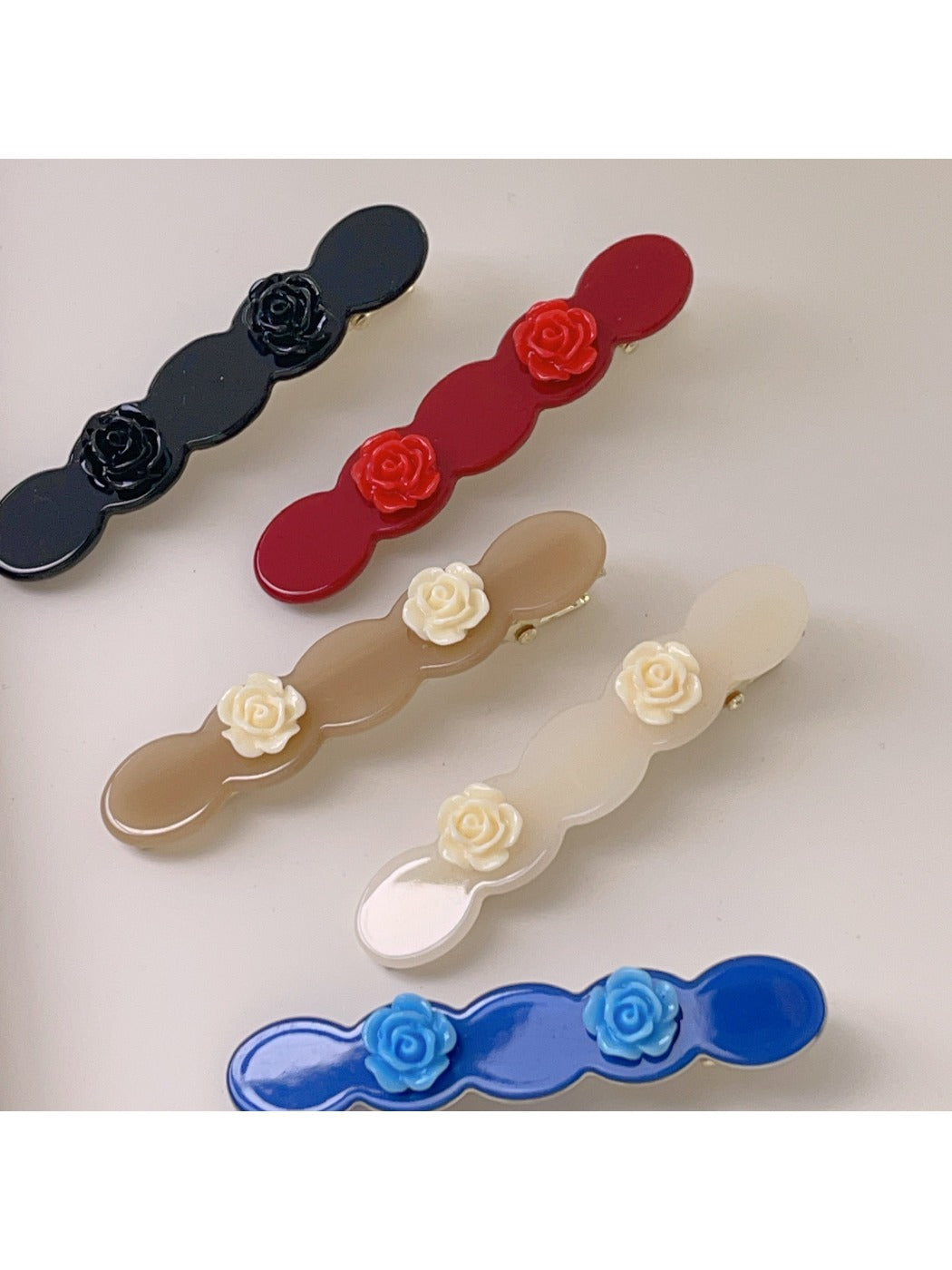 Side view of Beau rose decorated wavy hair clip highlighting clip mechanism