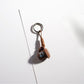 Brown tone cartoon keychain photographed against a plain background