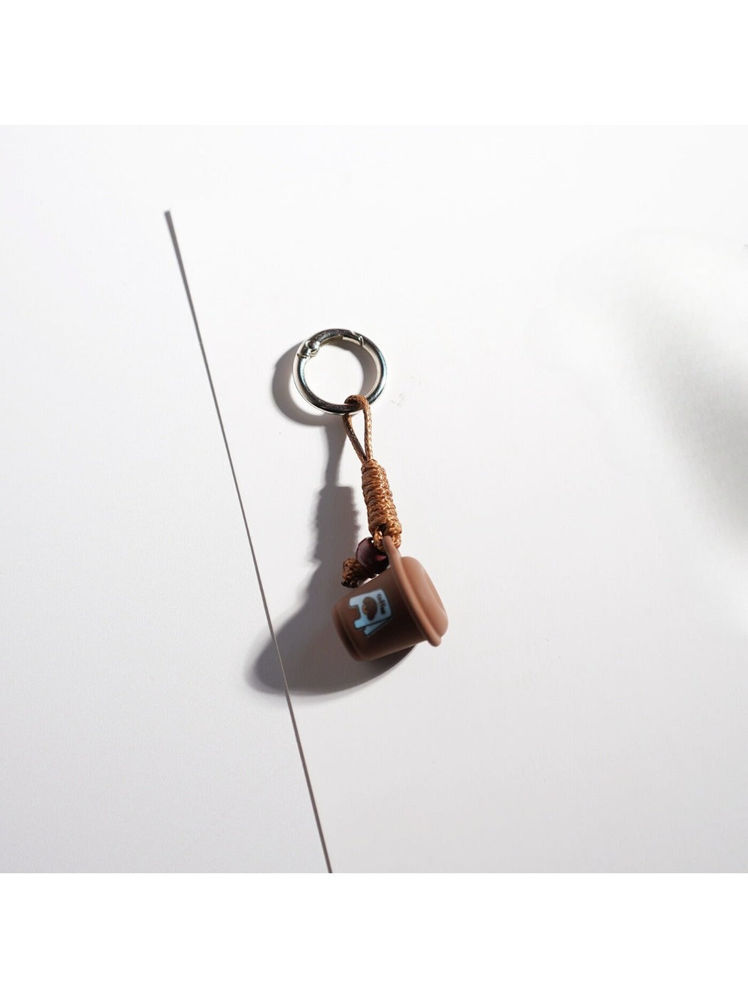 Brown tone cartoon keychain photographed against a plain background