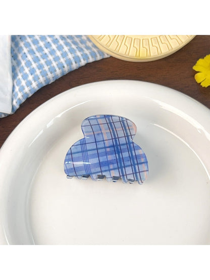 Blue plaid shark hair claw clip styled in model's hair