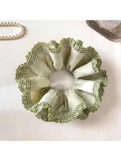 Green double layer scrunchie styled in long hair, showcasing its size and color