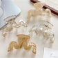 Beau hair claw clip open to display spring mechanism and teeth