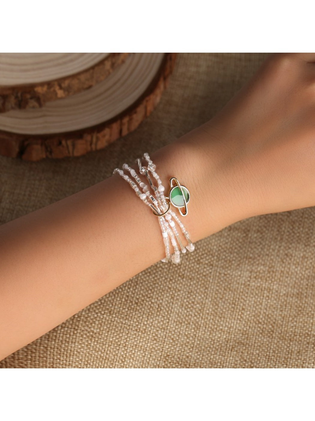 Lovra minimalist multi strand bracelet with small round beads in neutral tones on a white background