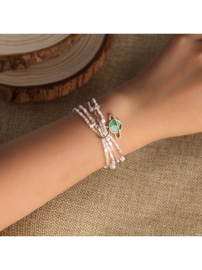 Lovra minimalist multi strand bracelet with small round beads in neutral tones on a white background