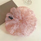 Close-up of pink tulle scrunchie showing delicate tiny floral details