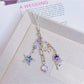 Purple star flower charm keychain displayed on a white background