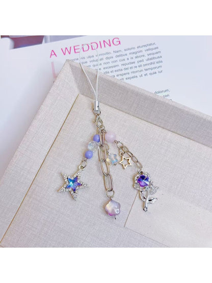 Purple star flower charm keychain displayed on a white background