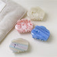 Beau dreamy cloud shaped hair claw clip in white, side view on a plain background