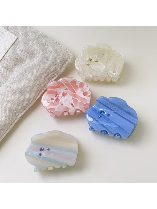 Beau dreamy cloud shaped hair claw clip in white, side view on a plain background
