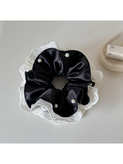 Beige lace trim satin scrunchie styled in a woman's hair