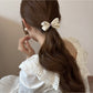 Gifty hair tie showing bow embellishment and elastic band on white background