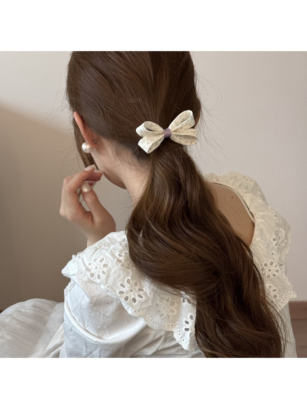 Gifty hair tie showing bow embellishment and elastic band on white background