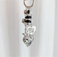 Heart shaped charm keychain displayed hanging from a hook against a neutral backdrop