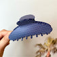 Beau polka dot acetate claw clip angled to show glossy finish and polka dots