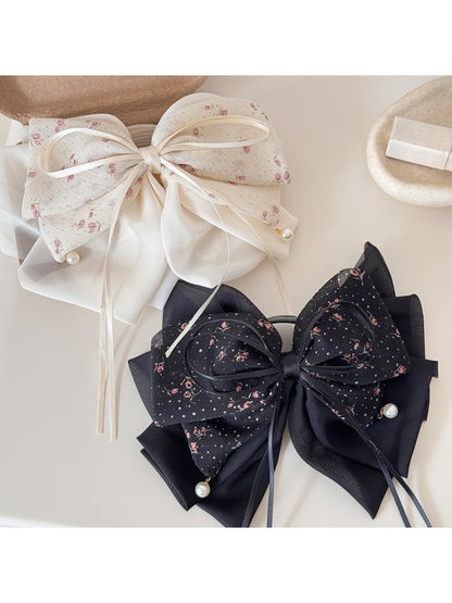 Beau elegant hair claw clip with a large bow accent in glossy black finish