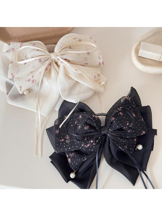 Beau elegant hair claw clip with a large bow accent in glossy black finish