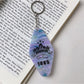 Keychain with diamond-shaped colorful pendant attached to a backpack zipper