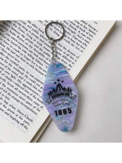 Keychain with diamond-shaped colorful pendant attached to a backpack zipper