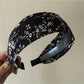 Gifty wide edge headband laid flat showing full floral pattern
