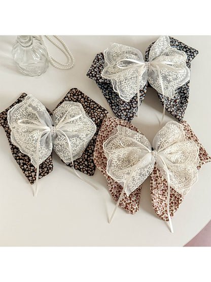 Beau tiny floral lace bow claw clip on white background