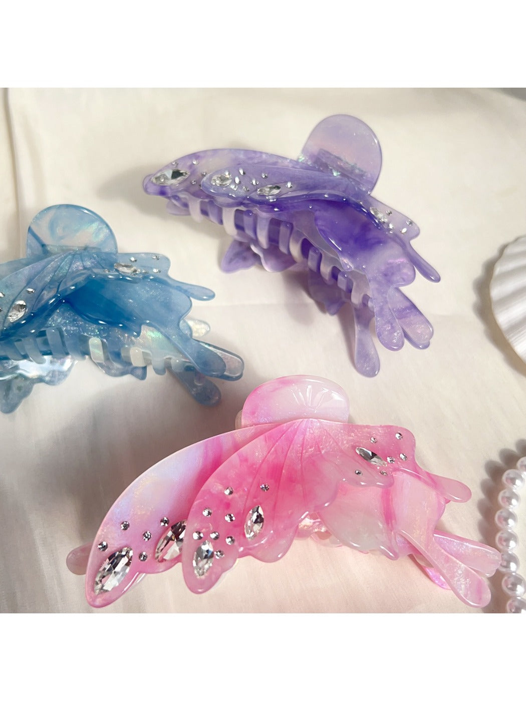 Butterfly hair claw clip open, displaying metal spring mechanism