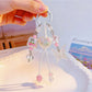 Close-up of heart shaped butterfly charm showing detailed wing patterns on keychain