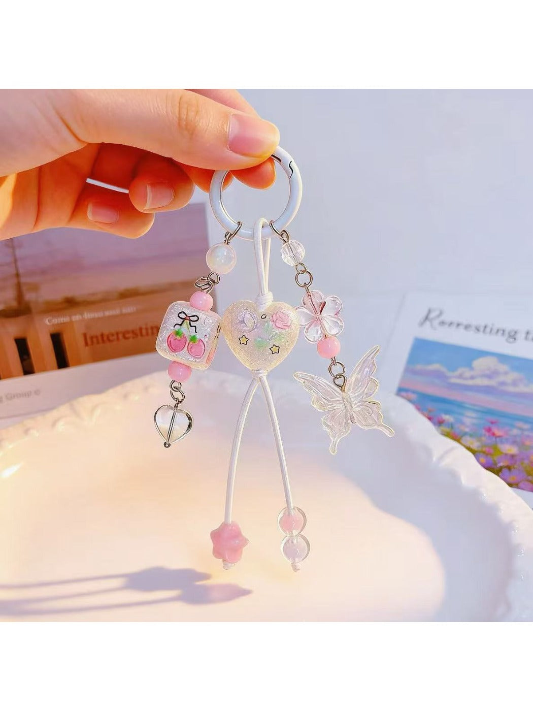 Close-up of heart shaped butterfly charm showing detailed wing patterns on keychain