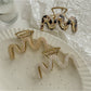 Beau vintage wave line claw clip held in hand to show size and shape