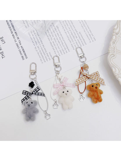 Side view of Keypus flocked bear bag charm highlighting its plush design