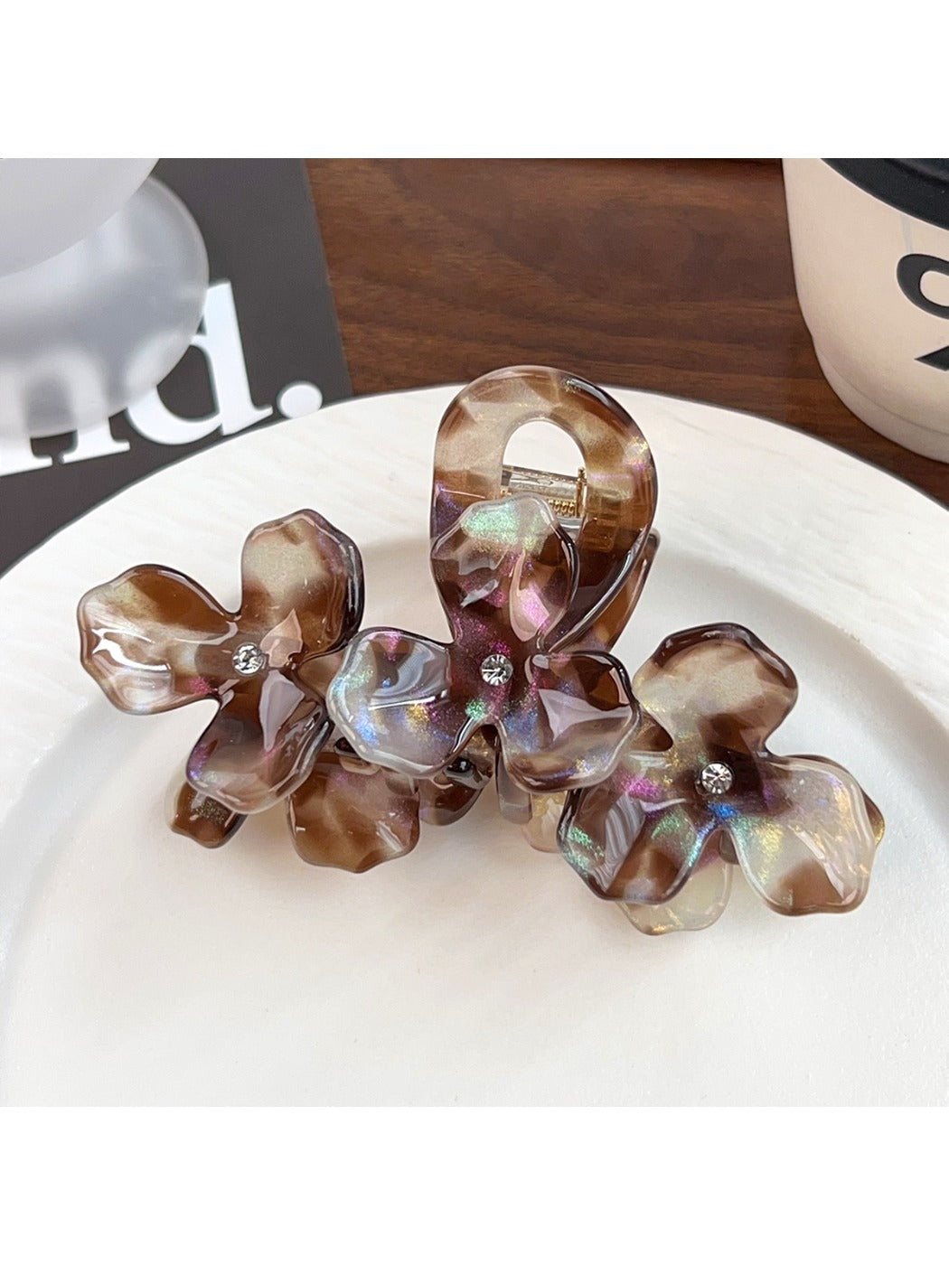 Beau elegant floral hair claw clip styled in long brown hair from back view