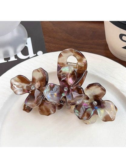 Beau elegant floral hair claw clip styled in long brown hair from back view